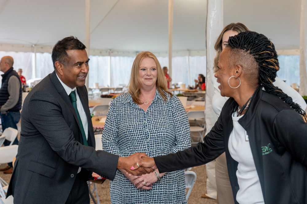Paari Gopalakrishnan meeting members of the medical staff during the 2025 Crab Feast