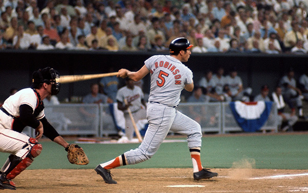 Brooks Robinson swinging a bat at homeplate