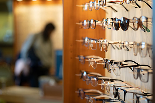 Eyeglasses on a display wall in an eye care office.