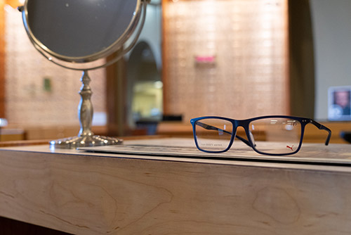 Eyeglasses sit on a table in an exam room.