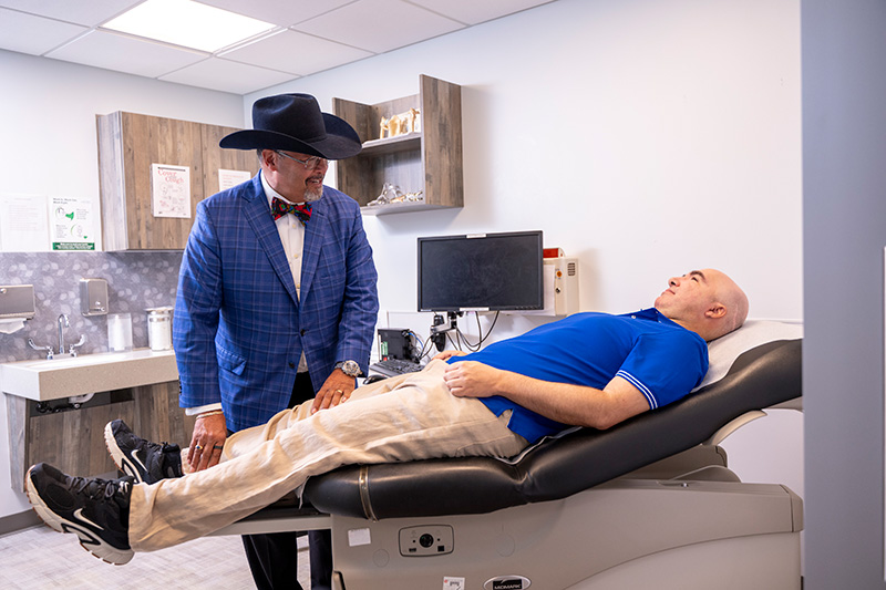 Ronald Delanois, MD, speaking with a patient