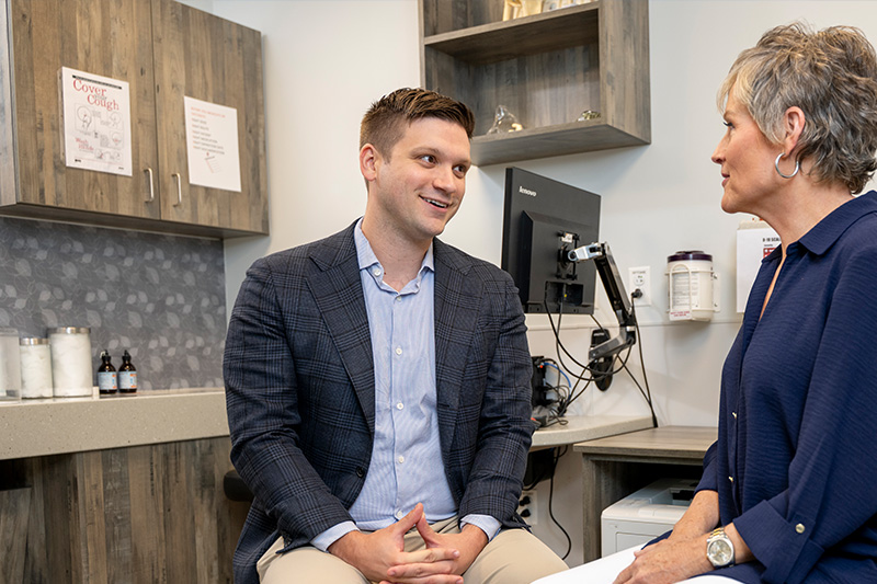 Ronald Delanois, MD, speaking with a patient