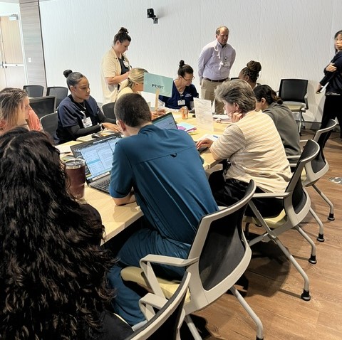 Unit participants flag a PT/OT team member to troubleshoot in real-time during Market Place Rounds.