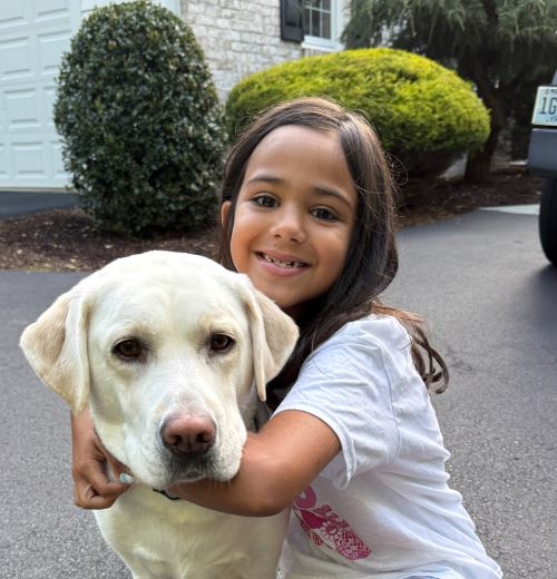daughter with Darby, the yellow Lab